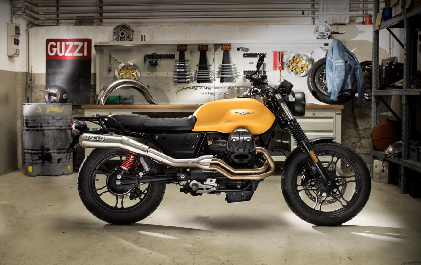 Moto Guzzi V7 in a workshop, with an Arrow exhaust.