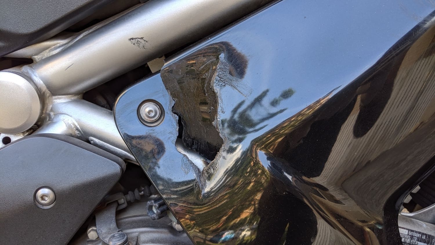 hole in motorcycle fairing that needs to be repaired.