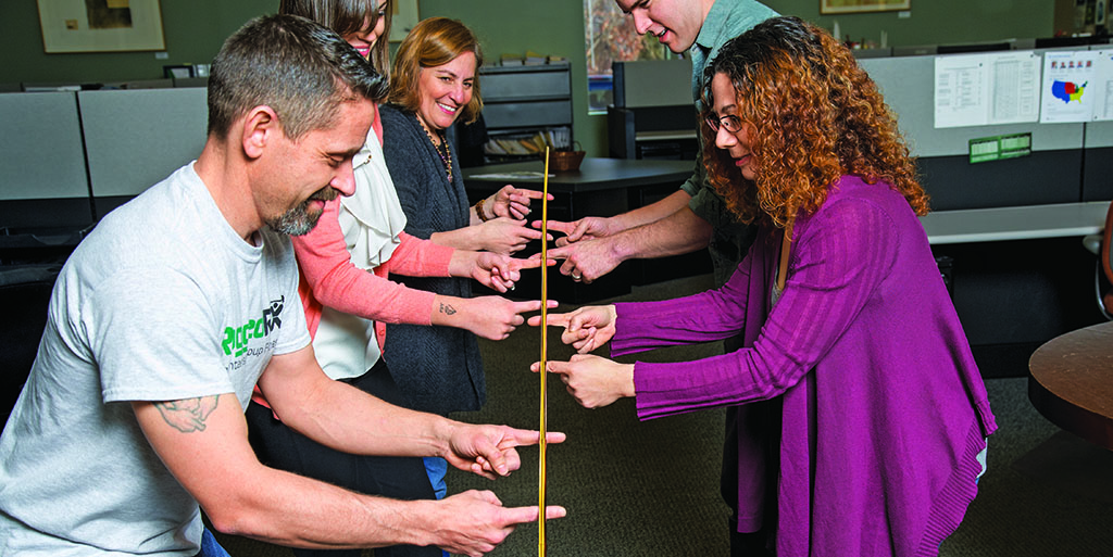 Helium stick exercise - everyone has to keep touching the stick
